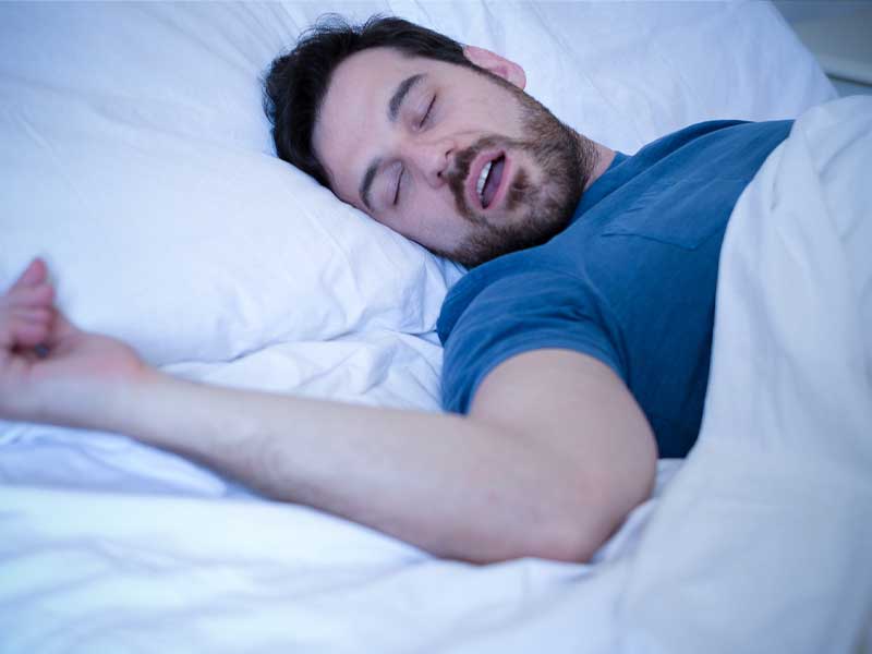 Man with sleep apnea not having a good nights sleep.